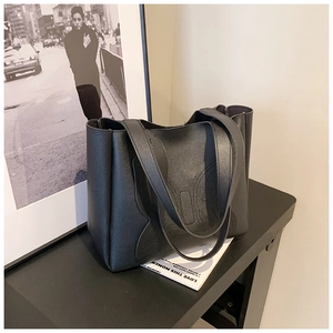 Detail of butterfly stitched pattern on high-quality black matte leather tote bag