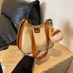Minimalist beige and brown colorblock tote bag with plush charm and fashion label