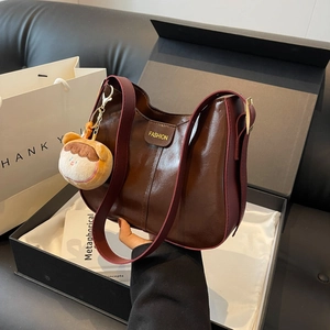 Brown soft leather tote bag with FASHION label and plush doll keychain in gift box