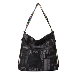 Black newspaper print tote bag with colorful LOVE strap for casual street style
