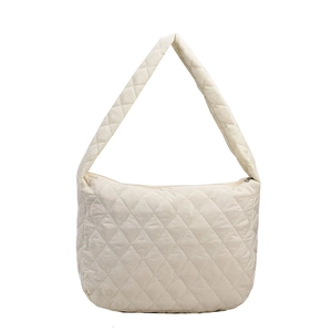Minimalist beige quilted puffer bucket bag with diamond stitching and shoulder strap