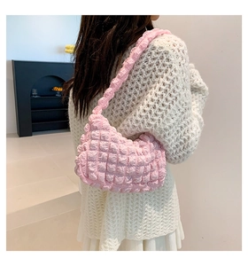 Detail of pink popcorn textured shoulder bag showing soft pleated fabric and 3D puffy pattern