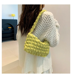 Detail of trendy lemon yellow puff shoulder bag with unique popcorn textured fabric