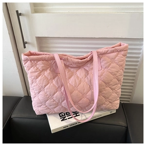 Detail of pink quilted tote bag with diamond lattice stitching on premium soft fabric