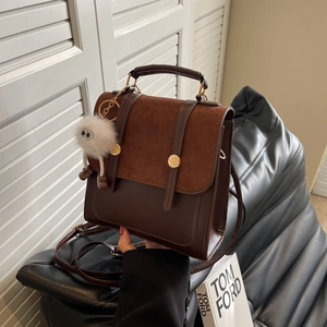 Vintage patchwork matte handbag in brown leather with a cute plush monster charm