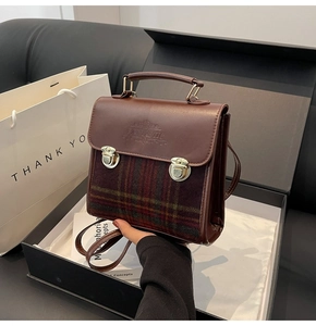 Detail view of vintage briefcase bag with fantastic logo and plaid fabric in gift box
