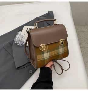 Detail of vintage plaid briefcase with metal buckles and Fantastic embossed logo