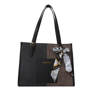 Fashionable two-tone tote bag in black and brown leather with silk scarf detail