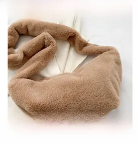 Detail of soft camel plush dumpling bag showing the fuzzy faux fur texture and wide strap