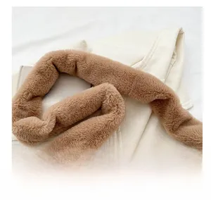 Detail view of the soft brown plush shoulder strap for winter dumpling bags