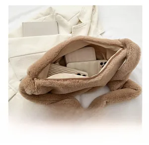 Detail view showing large interior capacity of the brown plush faux fur crossbody bag