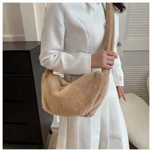Detailed texture of beige plush crossbody bag with soft fuzzy fabric and seamless strap