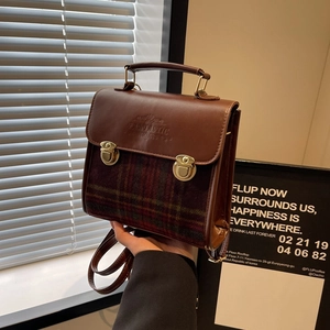 Vintage briefcase handbag with brown leather and plaid patterns featuring gold metal buckles