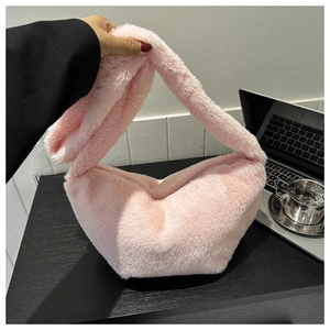 Detailed view of pink plush crossbody bag featuring soft faux fur and secure zipper closure