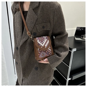 Détail du sac bandoulière vintage avec motif ethnique et bandoulière en cuir réglable