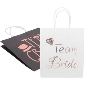 Close-up of Team Bride gift bags with metallic foil lettering and twisted rope handles