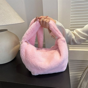 Chic pink plush dumpling bag with soft faux fur and metallic zipper for winter fashion