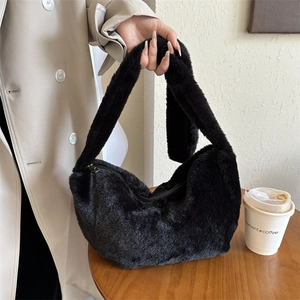 Fashionable black faux fur dumpling shoulder bag with silver zipper in cozy winter style
