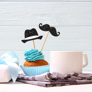 Father's Day cupcake toppers with glittery black hat and mustache on blue frosting cake