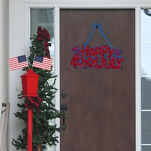 Happy 4th of July door sign hanging on a dark wood front door with red blue glitter