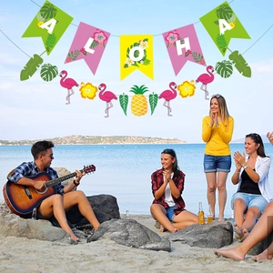 Hawaiian party decoration set with Aloha banner, flamingos, and tropical leaf garlands