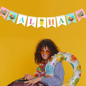 Close-up of tropical Aloha banner with pineapple motif and Tiki party decorations