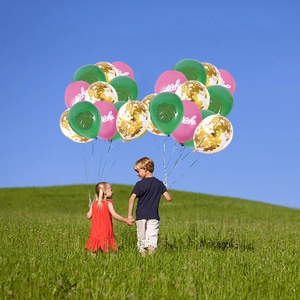 Tropical Hawaii party balloon set with Aloha text and palm leaves against a sunny sky