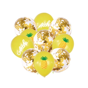 Close-up of Aloha party balloons with pineapple patterns and gold confetti filling