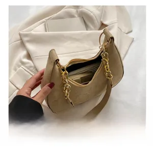 Detail view of khaki suede crescent bag interior showing daily essentials capacity