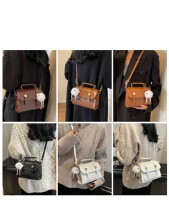 Close-up of retro small square crossbody bags in six colors with metal buckle and pompom charm