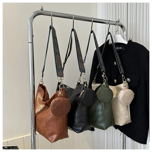 Detail of multi-color tote bags with jacquard straps and round coin purses
