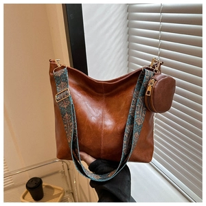 Detail of retro brown tote bag with bohemian pattern wide shoulder strap and mini pouch