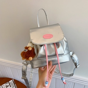 Vintage silver metallic backpack for women featuring pink drawstring and cute bear charm