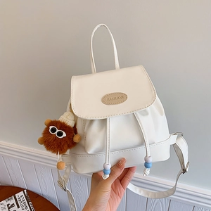 White faux leather drawstring backpack with cute plush monster charm accessory