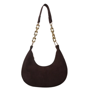 Dark brown suede hobo saddle bag with gold metal chain strap on a white background