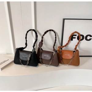 Detailed view of women's leather shoulder bags with woven handles and flower chain