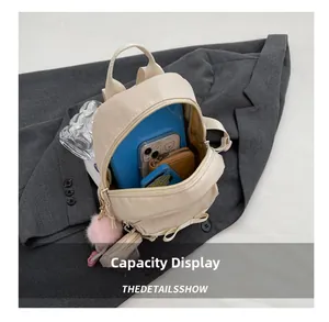 Internal view of cream nylon mini backpack showing capacity for tablet and accessories