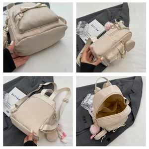 Detailed views of mini cream backpack featuring bow design, pom-pom charm and interior pockets