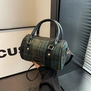Fashionable green plaid cylinder shoulder bag with black leather trim and top handles