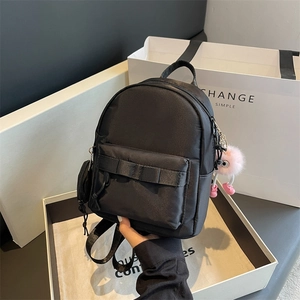 Black mini backpack for women with front zipper pocket and cute plush pendant charm