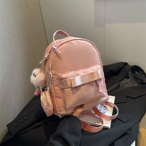 Pink mini nylon backpack for women with small round pouch and cute plush charm detail