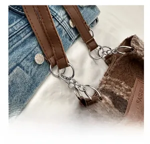 Detail of silver chain link and leather strap on vintage plaid wool tote bag