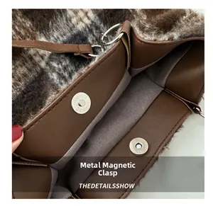 Detail view of the vintage plaid wool tote with magnetic metal clasp and brown lining
