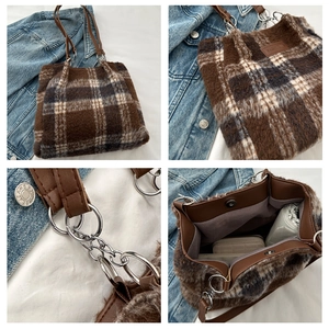 Detailed close-up of brown plaid fuzzy tote bag with leather strap and fashion label