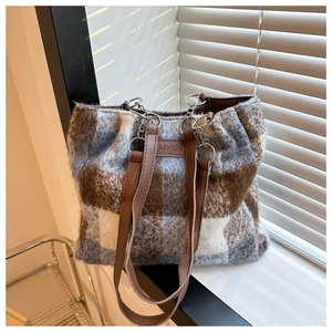 Detail of vintage plaid wool tote bag showing thick texture and metal ring buckle