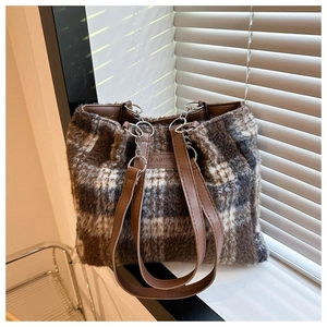 Detail of wool tote bag with brown plaid fur texture and fashion embossed strap