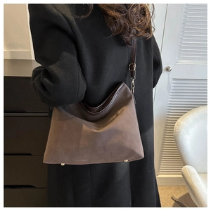 Brown faux suede tote bag featuring slim leather straps and elegant gold metal buckles
