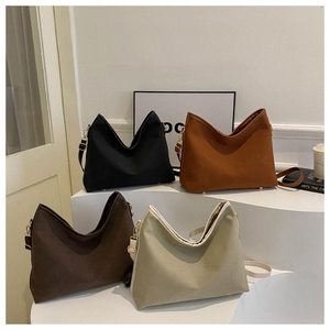 Four versatile tote bags in black, orange, brown, and cream with V-shaped openings