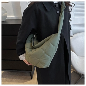 Olive green quilted crescent bag detail with decorative knot on wide shoulder strap