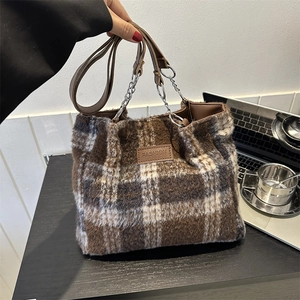 Brown and white checkered wool tote bag with leather handles and fashion label for winter